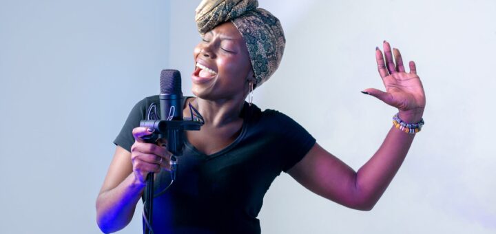 photo of woman singing in music studio
