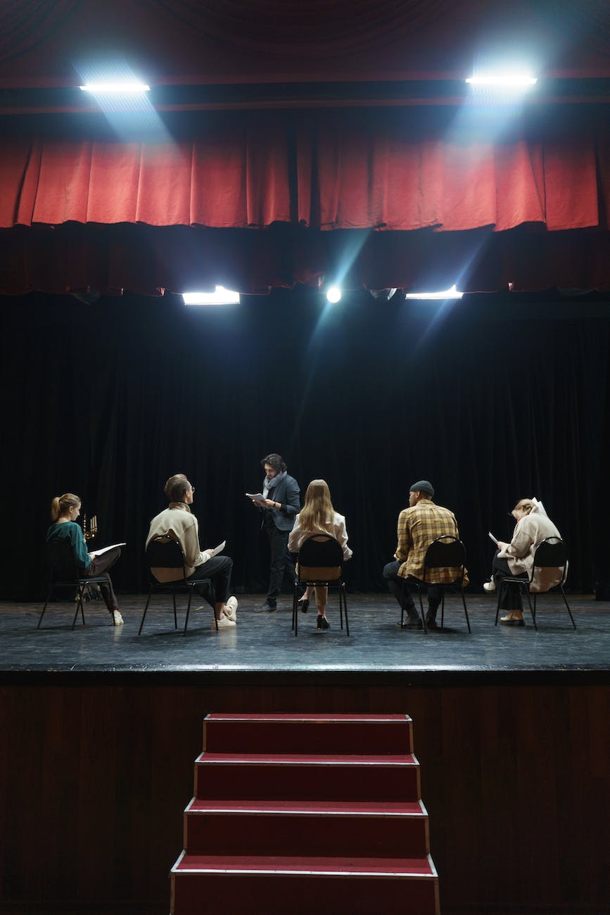 group of people sitting on chair on stage
