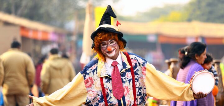 photo of clown holding tambourine