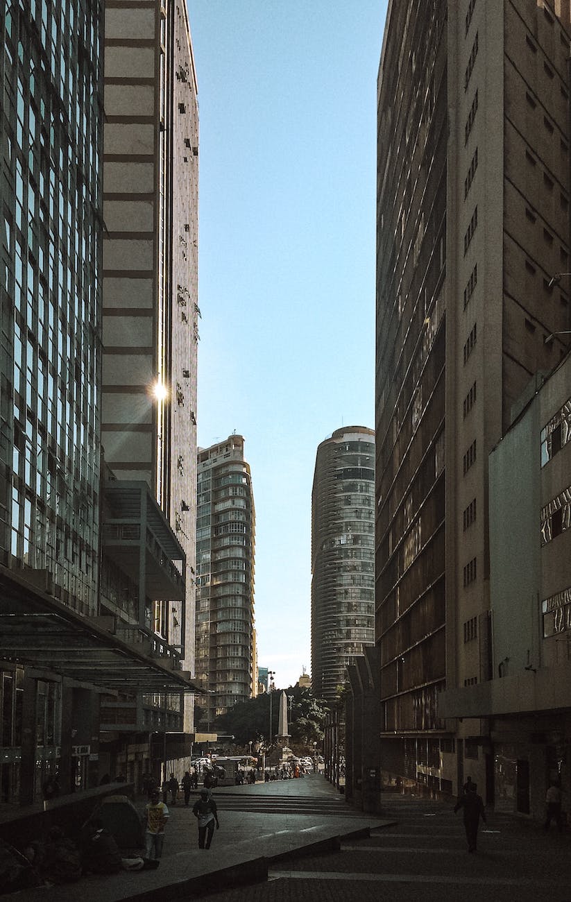 people walking on sidewalk near high rise buildings