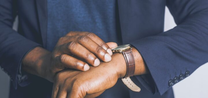 standing man looking his watch