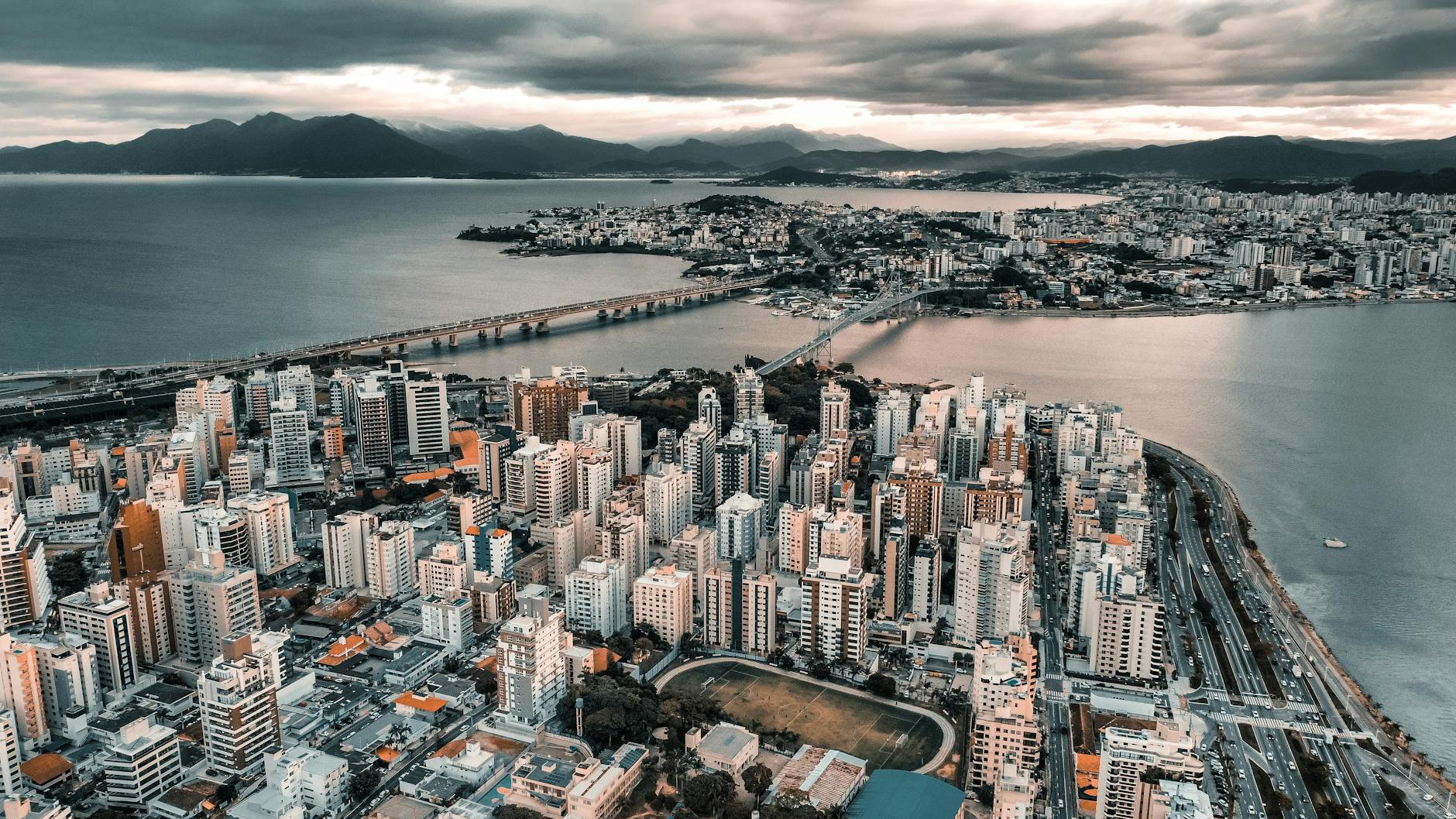 aerial view of city buildings near body of water